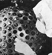 LAGEOS satellite with unidentified man during design phase.